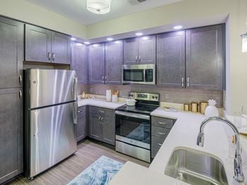Unique gray toned wood cabinetry with pantry
